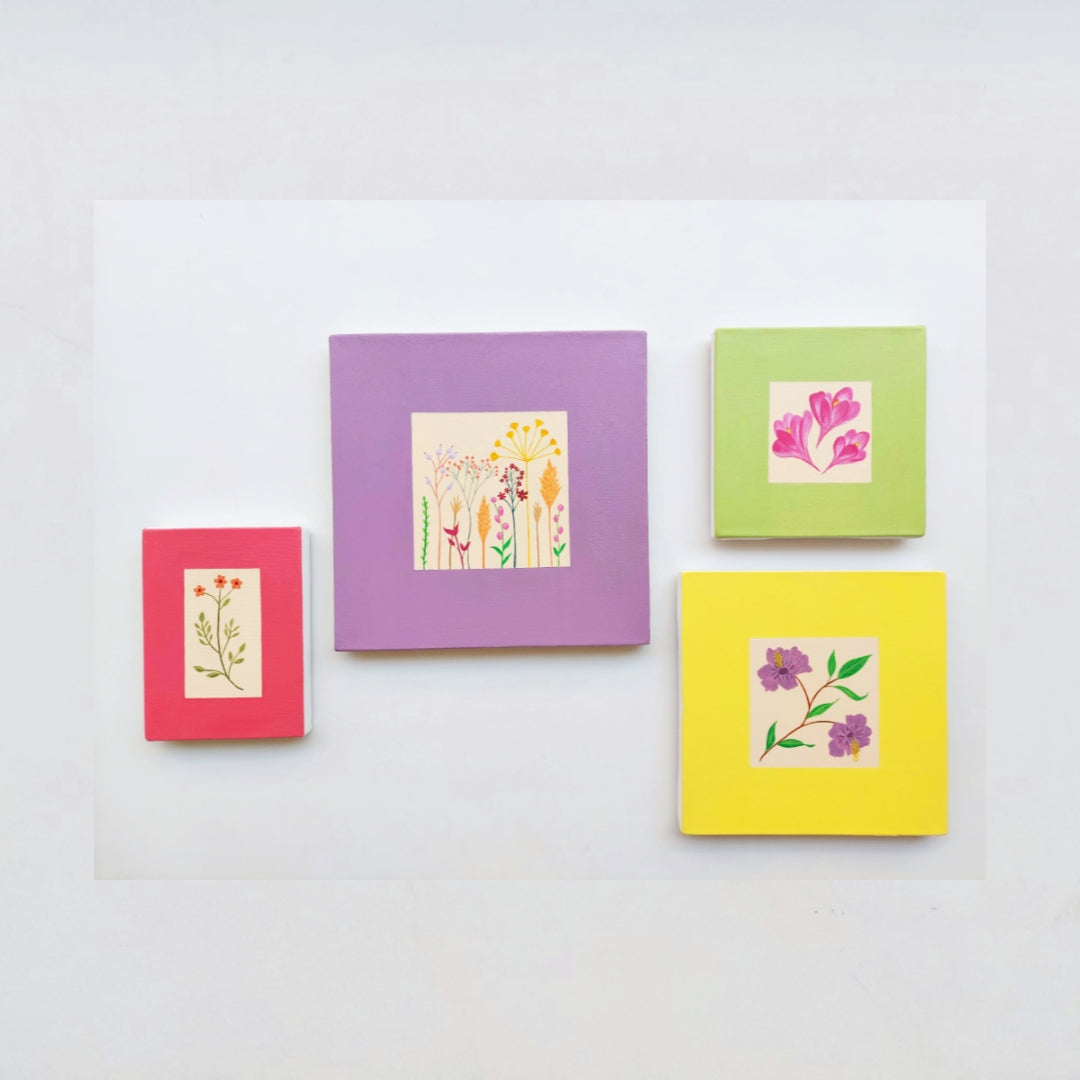 Four colorful square paintings with floral designs on a white background